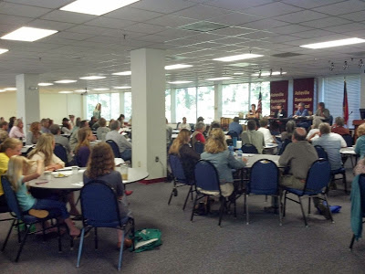 conference attendees listening to a group of panelists