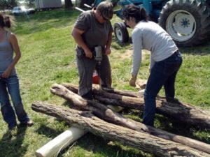 drilling holes for hardware before setting poles