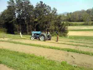 tractor with auger used to dig post holes